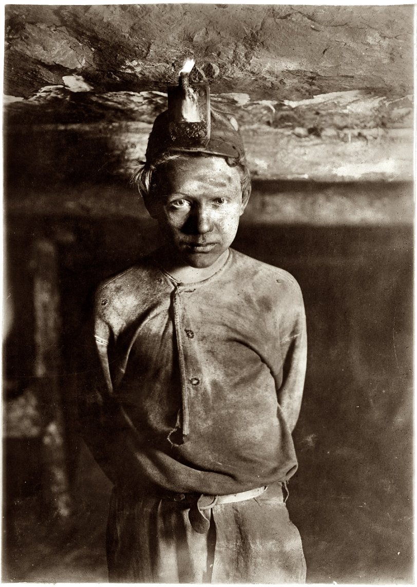 October 1908. "Trapper Boy, Turkey Knob Mine, Macdonald, West Virginia. Boy had to stoop on account of low roof, photo taken more than a mile inside the mine." Photo by Lews Wickes Hine.. View full size.