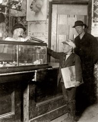May 1910. St Louis, Missouri. "Where the money goes to. Bach branch office usually has a candy counter. 4020 Manchester Street." One in a series of photos by Lewis Hine showing the "frivolous" uses to which newsies put their earnings -- money spent on candy, ice cream, the nickelodeon, etc. View full size.