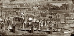 Richmond, Virginia, in April 1865 showing the burned district along the James River. From photographs of the main Eastern theater of war and fallen Richmond compiled by Hirst Milhollen and Donald Mugridge. View full size.

As the sun rose on Richmond, such a spectacle was presented as can never be forgotten by those who witnessed it. All the horrors of the final conflagration, when the earth shall be wrapped in flames and "melt with fervent heat," were, it seemed to us, prefigured in our capital. The roaring, crackling and hissing of the flames, the bursting of shells at the Confederate Arsenal, the sounds of the Instruments of martial music, the neighing of the horses, the shoutings of the multitudes, gave an idea of all the horrors of Pandemonium. Above all this scene of terror hung a black shroud of smoke through which the sun shone with a lurid angry glare like an immense ball of blood that emitted sullen rays of light, as if loath to shine over a scene so appalling. Then a cry was raised: "The Yankees! The Yankees are coming!" — Richmond resident Sallie Putnam

Upon evacuation of the city, the Confederate government authorized the burning of warehouses and supplies, which resulted in the destruction of factories and houses in the business district. Before the charred ruins of Richmond had cooled, General Robert E. Lee, with the remnant of his army, surrendered to Ulysses Grant at Appomattox Court House on April 9, 1865. [From Embattled Capital, on the National Park Service's Richmond National Battlefield web page.]