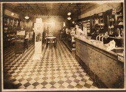 My grandparents bought this drugstore in 1957 from Mr. Adams (pictured). The back of the photograph reads: We're unsure- but this may have been Adams Drug Co in the 30's, 40's? We bought it in 1957 and fixtures like these + the tin ceiling were in it then. Ralph + Daphne Ashworth July 1997

My grandfather still works here, along with my uncle who now runs the business. My father, brother, and myself work upstairs of the drugstore (former Mason Lodge) running a chain of retail stores.

Location: Ashworth Drugs 105 W. Chatham St. Cary, NC 27511


