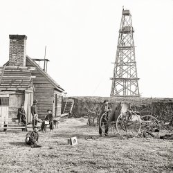 1864. "Bermuda Hundred, Virginia. Photographer [possibly Mathew Brady] at Butler's signal tower, Cobb's Hill, Appomattox River. Wet plate glass negative from photos of the main Eastern theater of war, the Army of the James, June 1864-April 1865. African American man standing along with Signal Corps." Note the camera lens on the grass, and cloth-draped darkroom on the wagon. View full size.