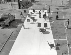 &nbsp; &nbsp; &nbsp; &nbsp; Somewhere around Los Angeles circa 1958. "Aluminum Group furniture (chairs, ottomans, tables) designed by Charles Eames for Herman Miller Inc." Large format negative from the Office of Charles and Ray Eames.
Back again at the waiting room without walls, this time a bit earlier in the day, we get our second look at these people, including Ray Eames, striding along at the upper right. New to the scene is a photographer wielding a Hasselblad, a medium format camera much favored by professionals. View full size.