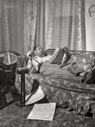 April 1942. "Mr. Oliver Coleman, drummer, looking over some music scores in the study of his apartment on Indiana Avenue. Chicago, Illinois." Acetate negative by Jack Delano for the Foreign Information Service of the U.S. Office of Coordinator of Information. View full size.