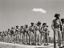 June 1942. "Edgewood Arsenal, Maryland. Gas demonstration. Soldiers wearing gas masks after having been sprayed with gas from a plane." Photo by Jack Delano for the Office of War Information. View full size.