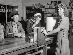 March 1943. "Truck transportation between New Orleans and Texas. Truck driver and sailor at a highway coffee shop on U.S. Route 90 in southern Louisiana." Medium format acetate negative by John Vachon for the Office of War Information. View full size.