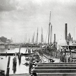 Circa 1865. "City Point, Virginia. Unloading Federal supplies from transports." Civil War glass negative collection, Library of Congress. View full size.