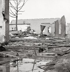 April 1865. "Richmond, Virginia. Destroyed Richmond & Petersburg locomotive." Aftermath of the Confederate evacuation in which Richmond's business district, accidentally torched by its own citizens, burned to the ground, the flames extinguished only with the aid of the occupying Federal Army. View full size.