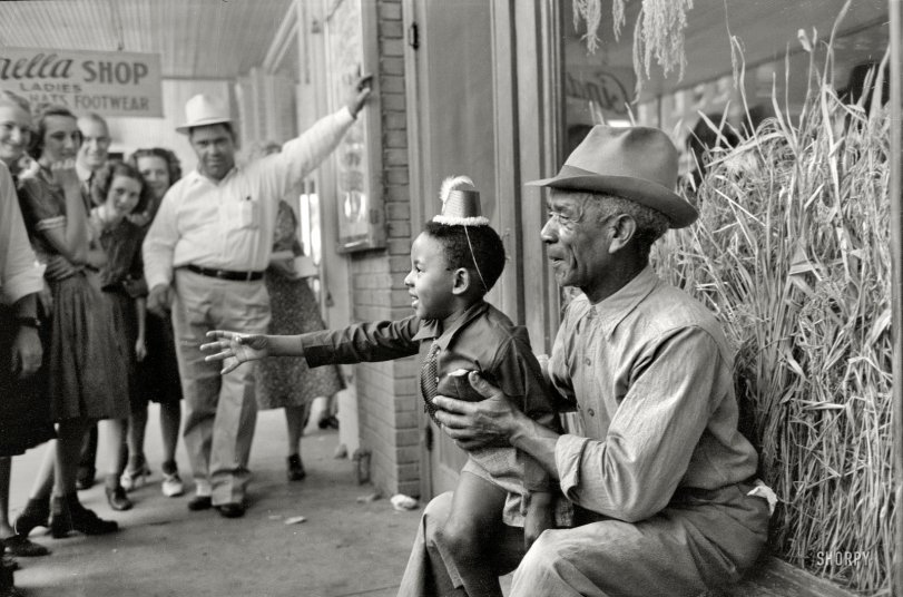 October 1938. "Spectators at National Rice Festival parade in Crowley, Louisiana." 35mm negative by Russell Lee, Farm Security Administration. View full size.