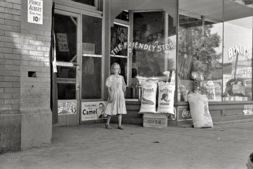 June 1939. "Child coming out of grocery store in Webbers Falls, Oklahoma." 35mm negative by Russell Lee, Farm Security Administration. View full size.